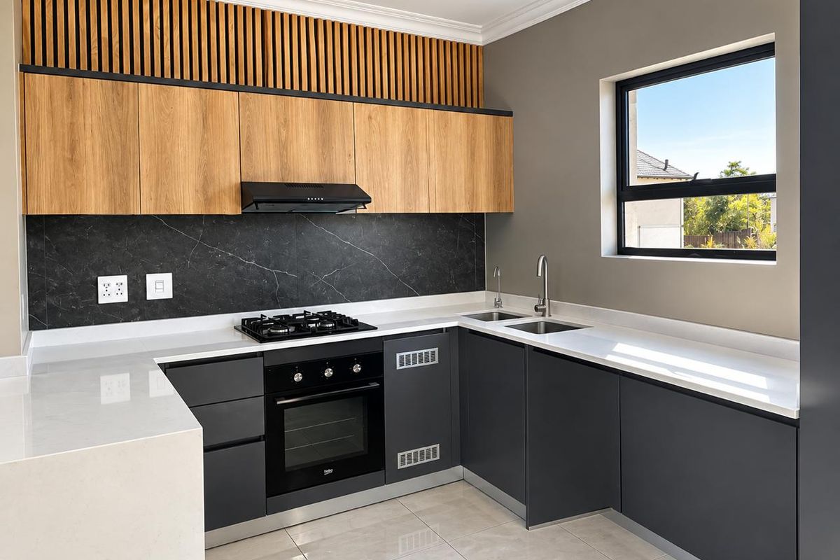 Modern kitchen featuring sleek dark cabinetry, light wood accents, stone countertops, integrated gas cooktop, built-in oven, and a stylish marble-look splashback.