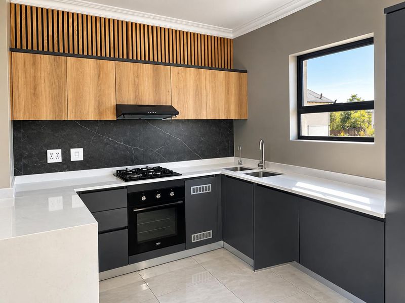 Modern kitchen featuring sleek dark cabinetry, light wood accents, stone countertops, integrated gas cooktop, built-in oven, and a stylish marble-look splashback.