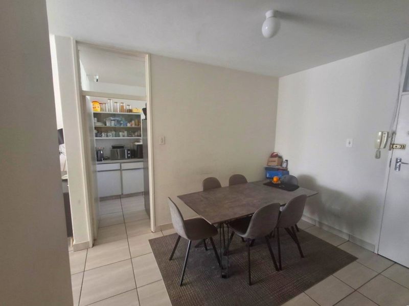 A functional dining area featuring tiled flooring and direct access to the adjacent kitchen space.