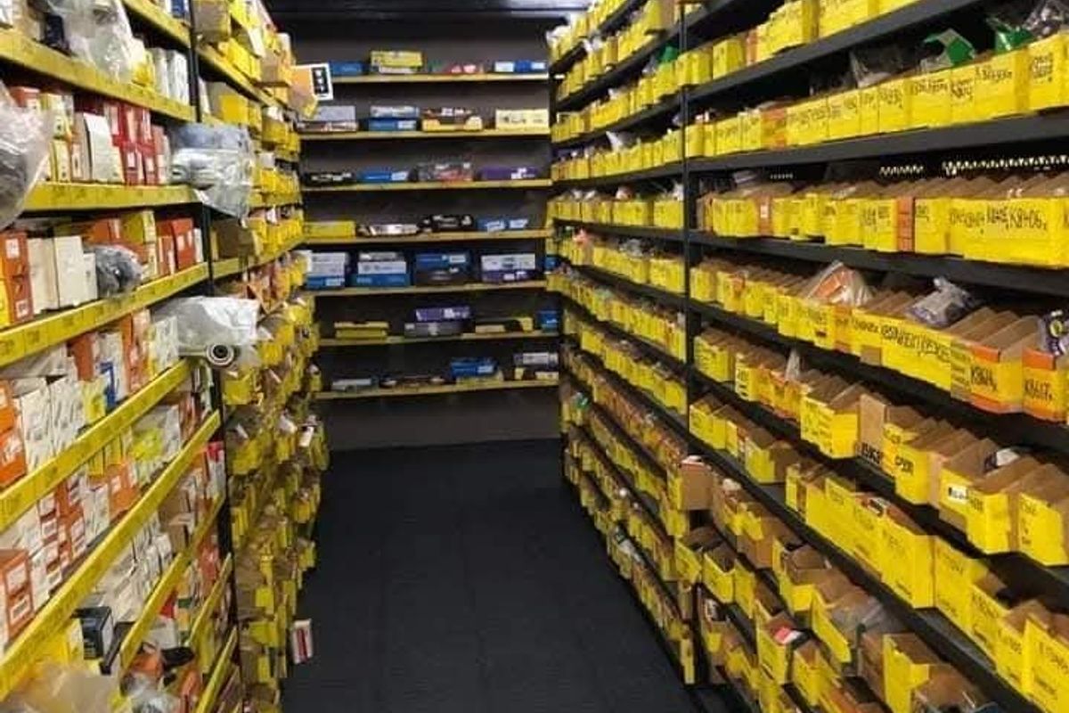 A commercial storage or utility space featuring extensive industrial metal shelving units organized for inventory management.