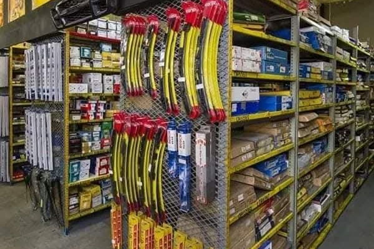 Commercial utility space featuring extensive industrial metal shelving and wire mesh display systems for organized inventory storage.
