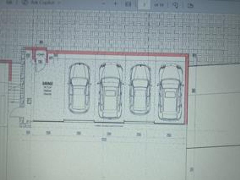 A digital floor plan showing a four-car garage layout with dimensions.