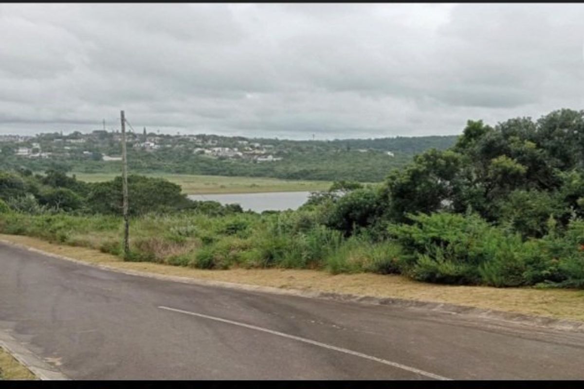 A view of the surrounding landscape and water body from the paved road adjacent to the vacant residential land.