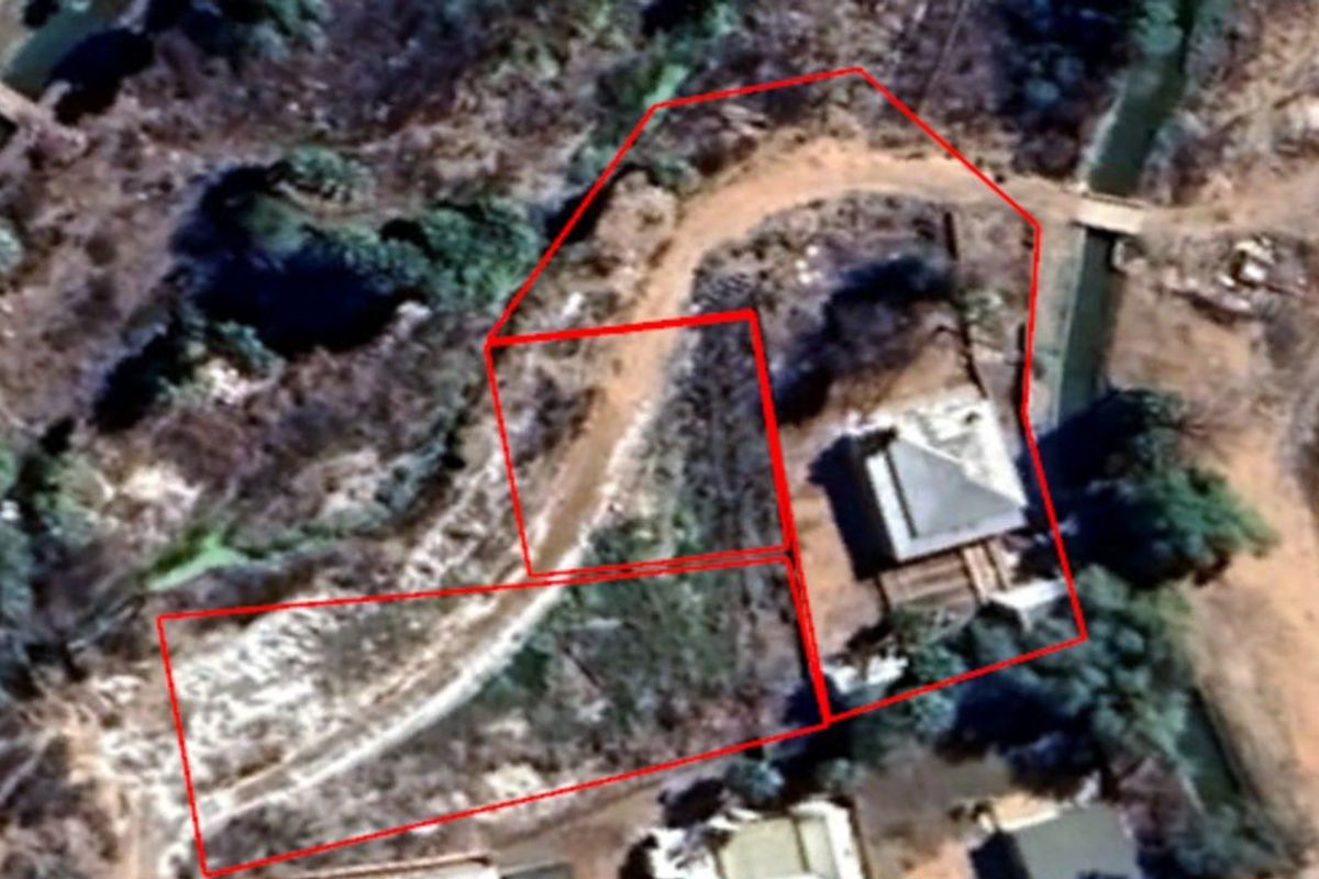 An aerial satellite view showing the property layout, roof structure, and surrounding land boundaries.