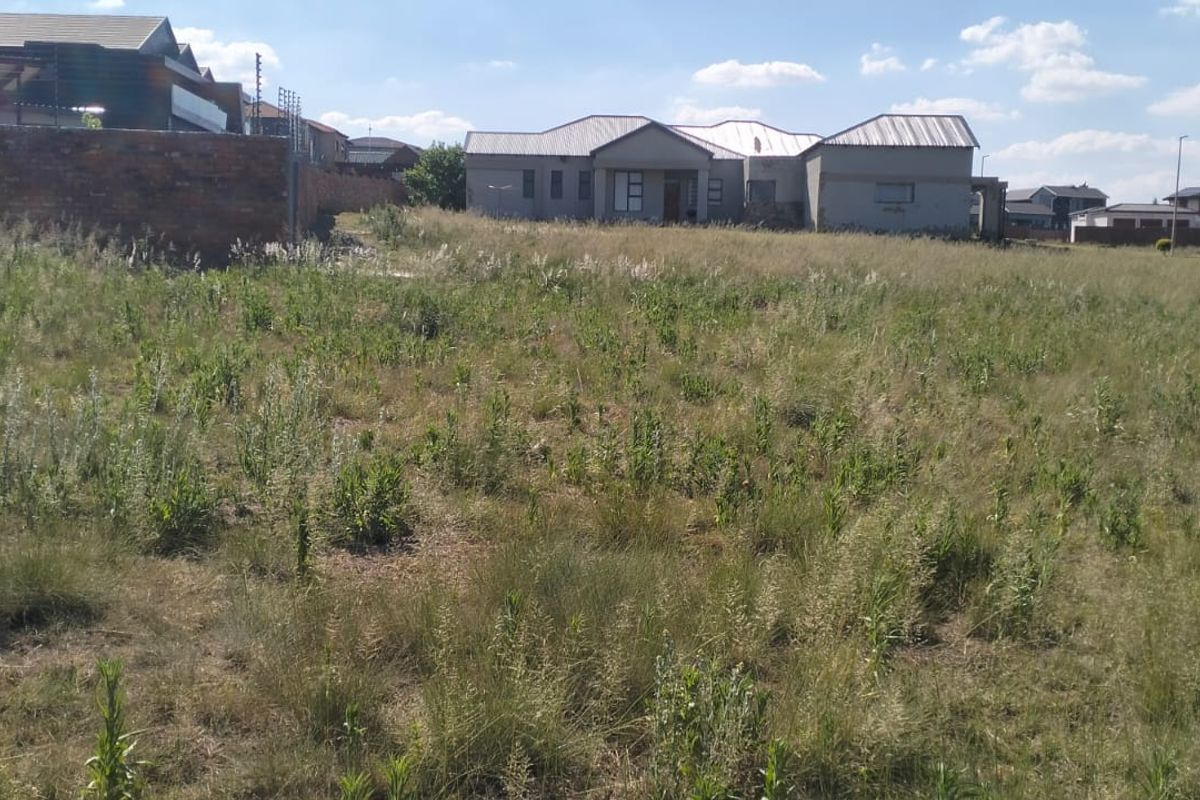 A vacant residential plot of land situated in a developed neighborhood, offering a clear space ready for future construction.