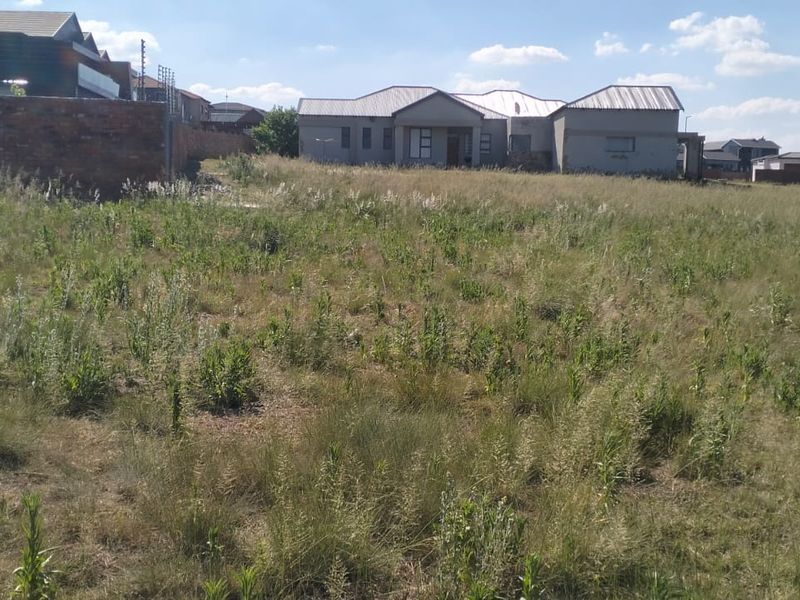 A vacant residential plot of land situated in a developed neighborhood, offering a clear space ready for future construction.