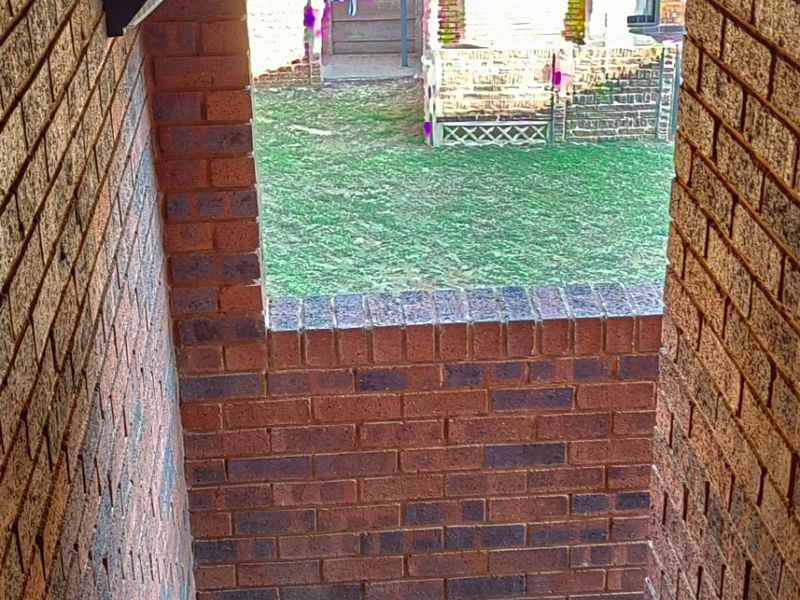 An exterior brick staircase with slate tiling leading down to a rear garden area.