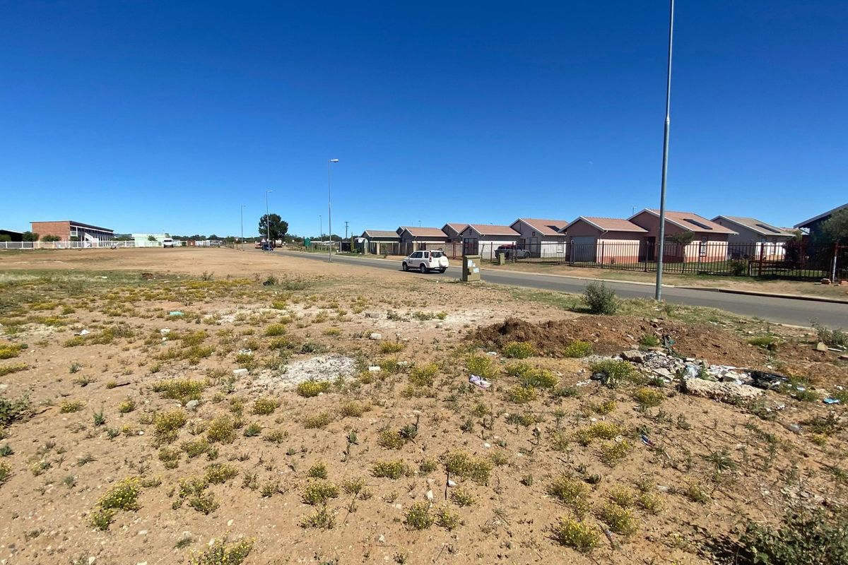 A view of the street frontage and surrounding residential neighborhood, showing the vacant land's position relative to existing infrastructure.