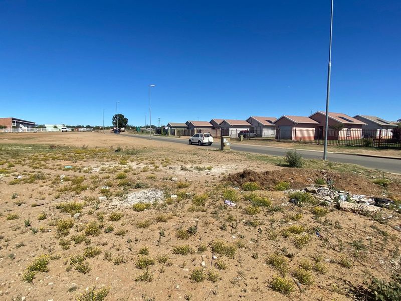 A view of the street frontage and surrounding residential neighborhood, showing the vacant land's position relative to existing infrastructure.