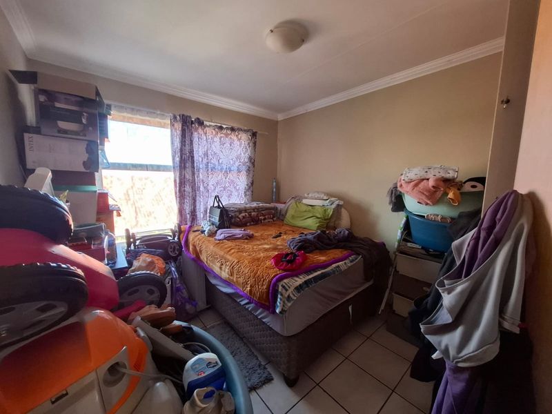 A bedroom featuring tiled flooring and standard ceiling finishes, offering a functional space ready for personalization.