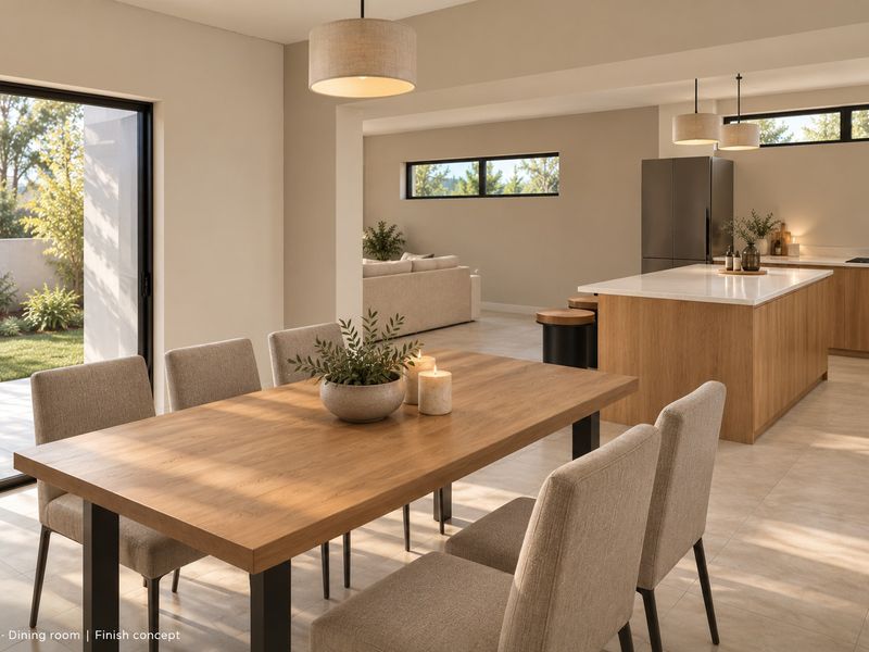 Modern open-plan living and dining area featuring a sleek kitchen with a central island, stone countertops, and large sliding doors opening to the garden.