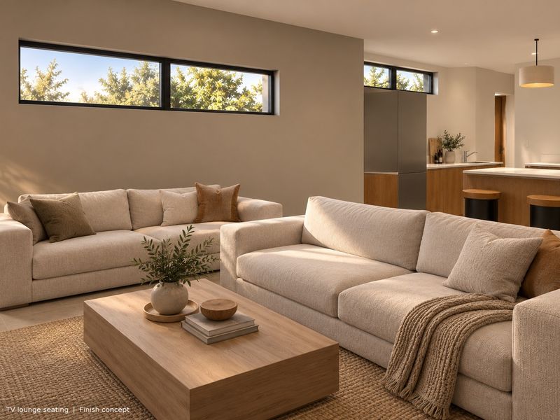 Modern open-plan living area featuring a seamless transition to a contemporary kitchen with island, complemented by high-level clerestory windows and neutral finishes.
