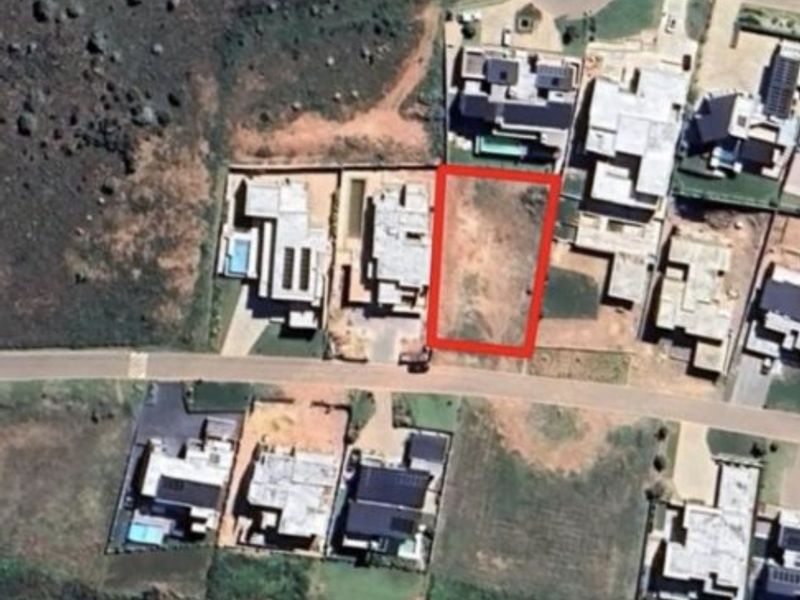 Aerial view of a vacant residential plot in a developed estate, showing the property boundaries and surrounding neighborhood context.