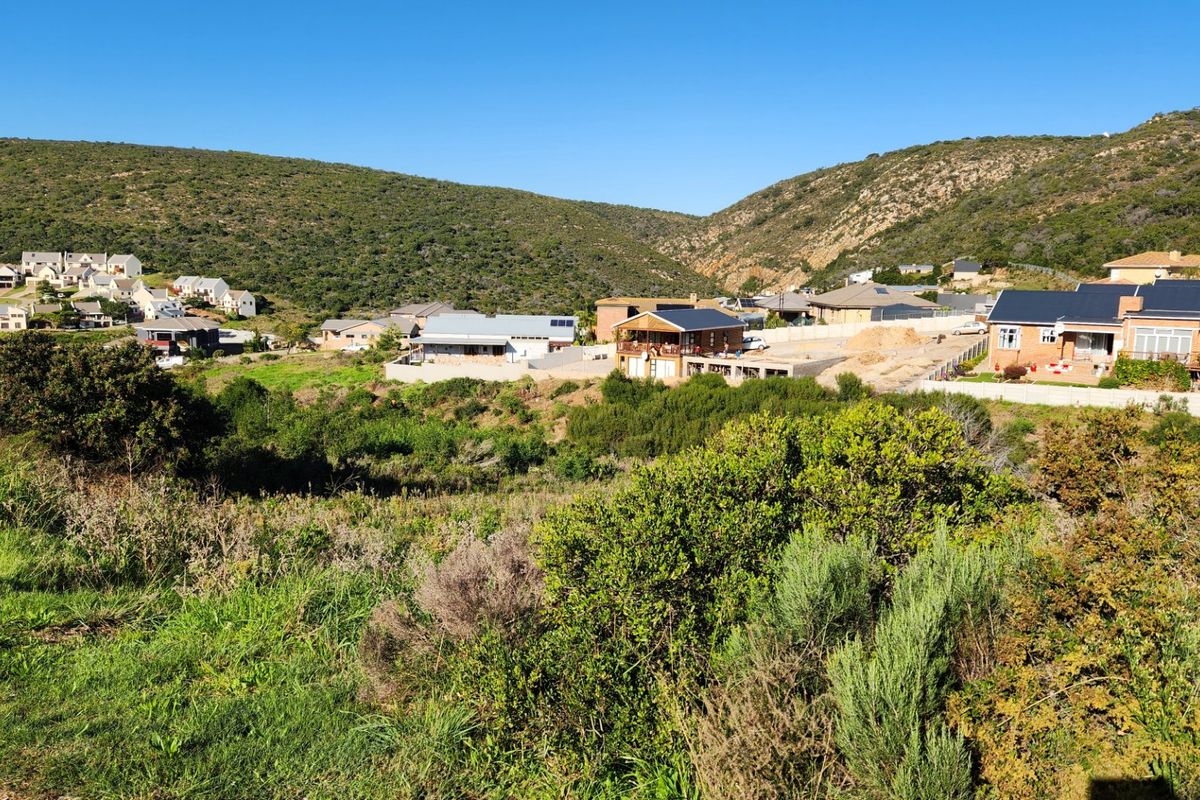 A scenic view of the surrounding residential estate and natural hilly landscape, showcasing the property's location within the neighborhood.