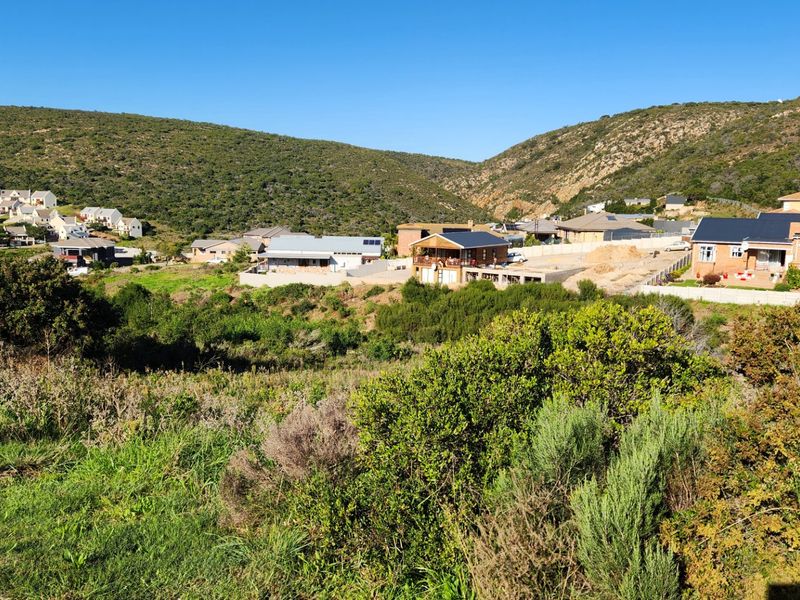 A scenic view of the surrounding residential estate and natural hilly landscape, showcasing the property's location within the neighborhood.