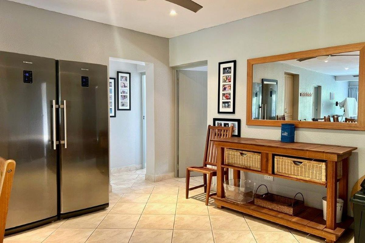 A functional kitchen area featuring tiled flooring, a ceiling fan, and recessed lighting, providing a practical space for daily use.