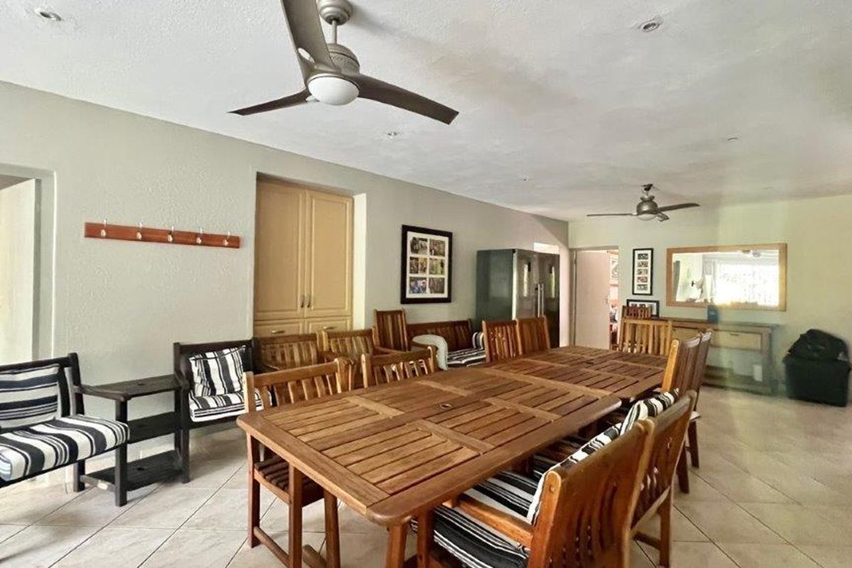 Spacious living area featuring tiled flooring, recessed lighting, ceiling fans, and built-in cabinetry, offering a versatile layout for dining or relaxation.