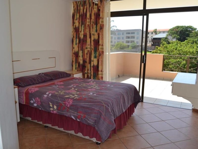 Bedroom featuring tiled flooring and a sliding glass door providing direct access to a private balcony with exterior views.