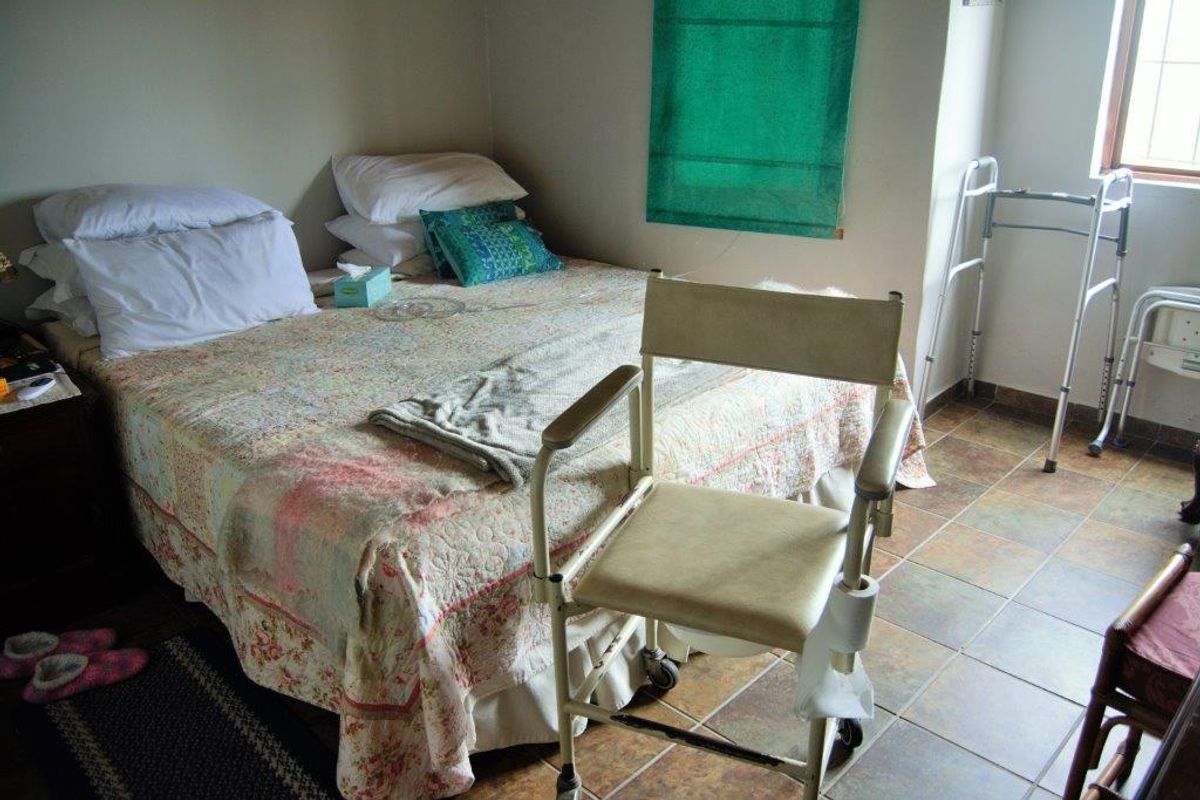 A functional bedroom featuring tiled flooring and a window, providing a practical living space within the farm property.