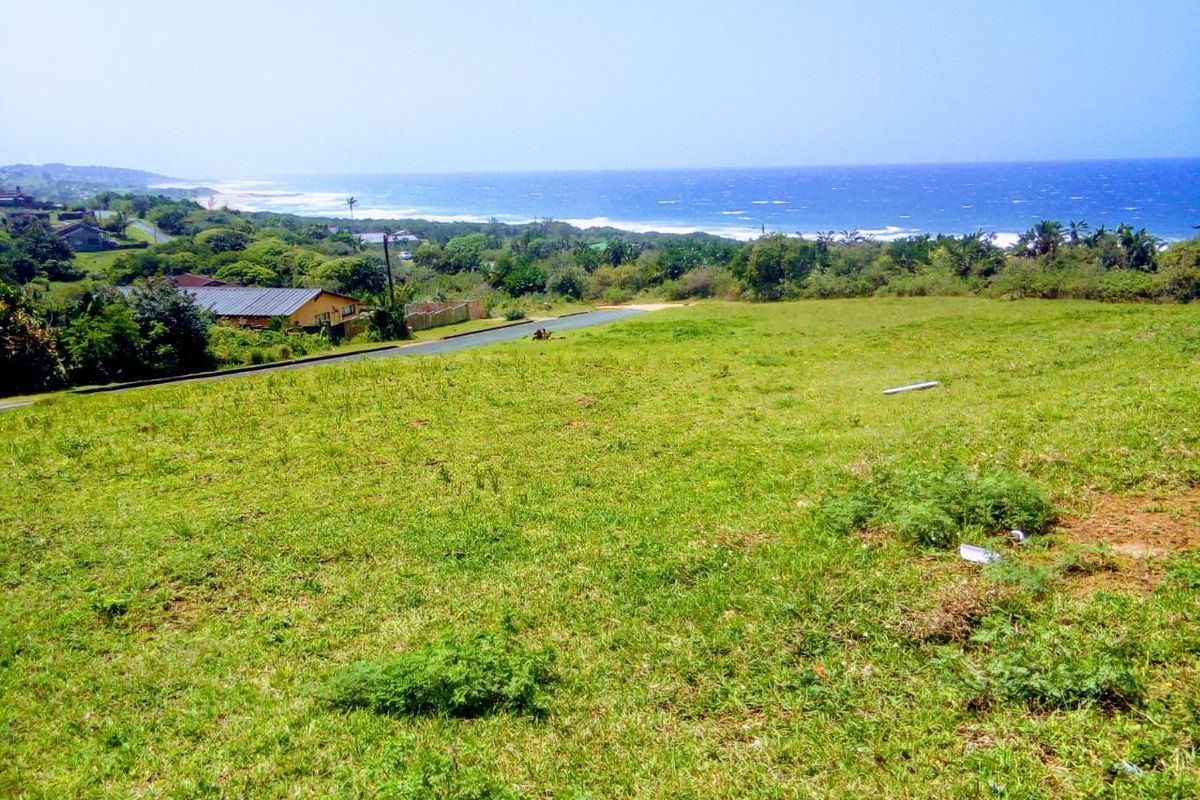 A vacant residential plot featuring a gentle slope and expansive, elevated views of the surrounding coastline and ocean.