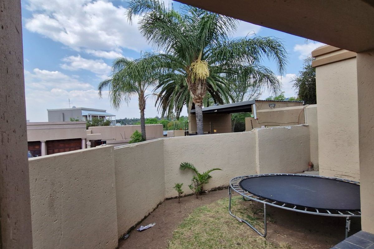 A rear courtyard area featuring a boundary wall and a built-in braai, providing a private outdoor space.