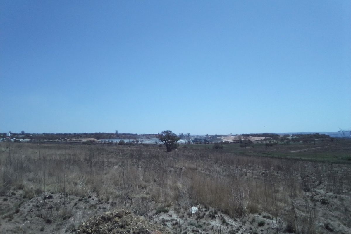 A wide-angle view of the vacant residential land, showcasing the natural landscape and surrounding terrain.