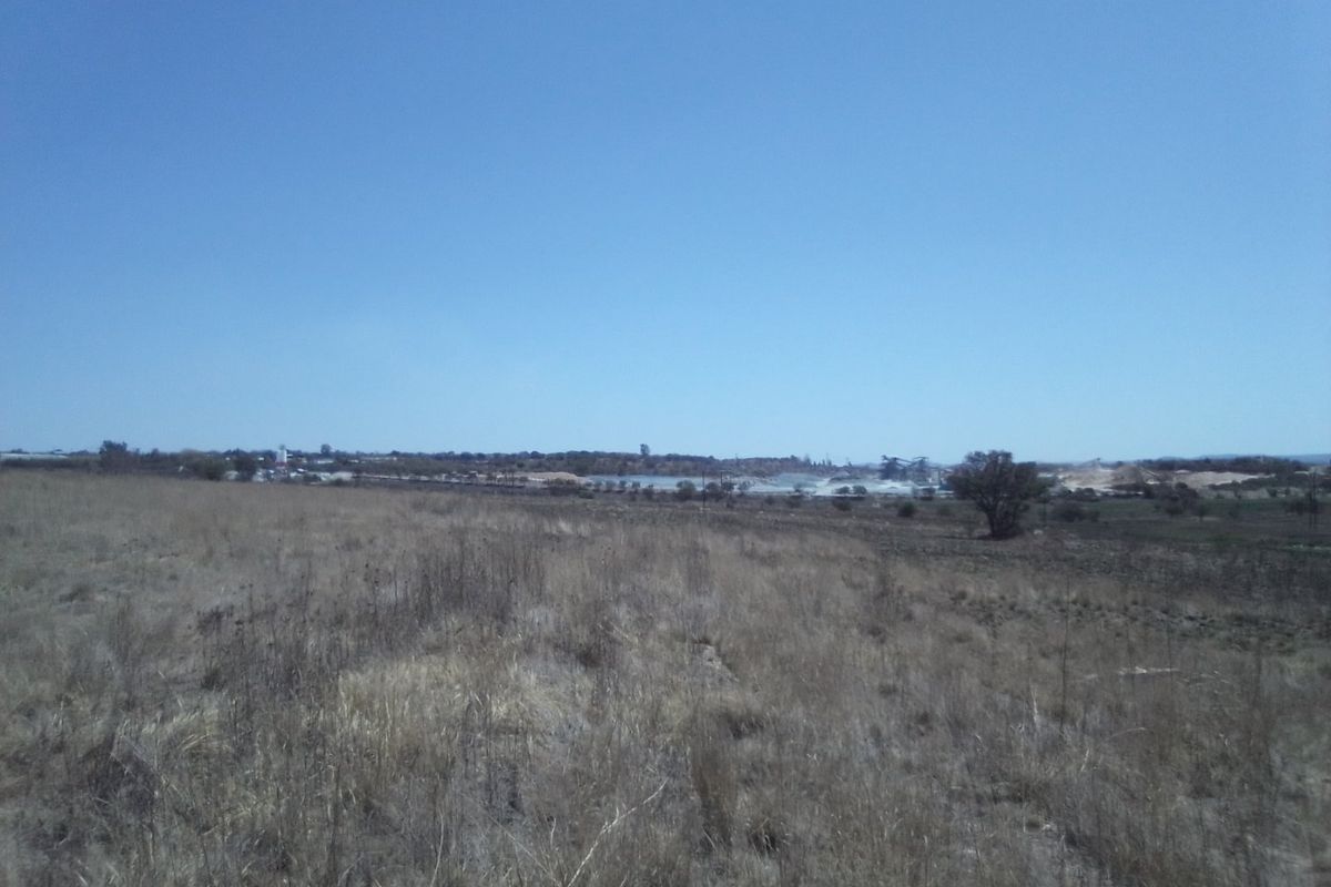 A wide-angle view of the vacant residential land, showcasing the natural landscape and surrounding area.