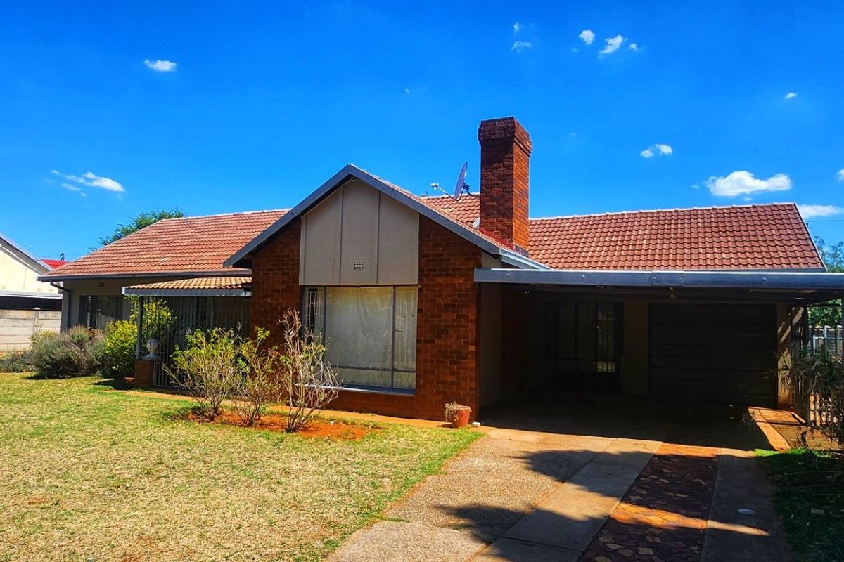 This 3-bedroom family home in Stilfontein offers space, security, and comfort for modern living. - Photo 2