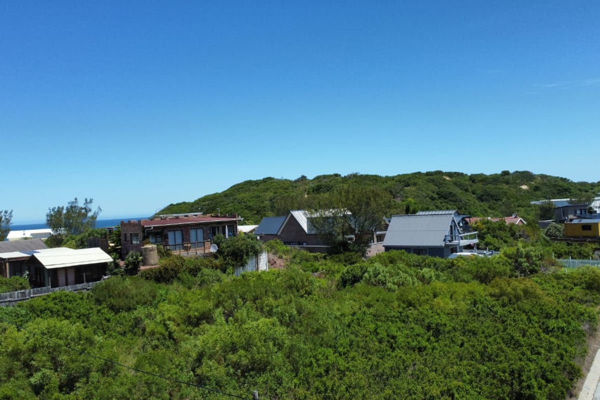 An elevated view of the surrounding residential neighborhood and coastal landscape, showcasing the local environment and nearby properties.