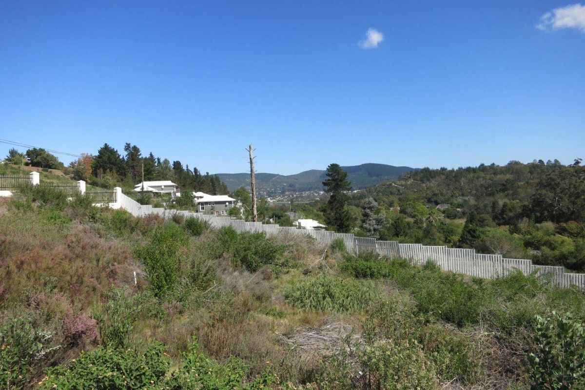A scenic view overlooking the vacant residential land, featuring established perimeter fencing and a backdrop of rolling hills and natural vegetation.