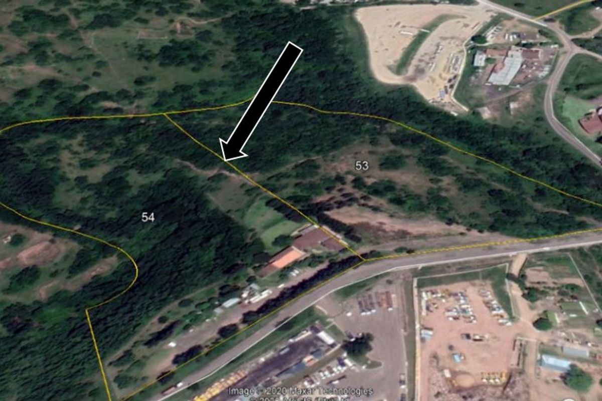 An aerial view showing the boundaries of land parcels 53 and 54, featuring natural vegetation and proximity to local road infrastructure.