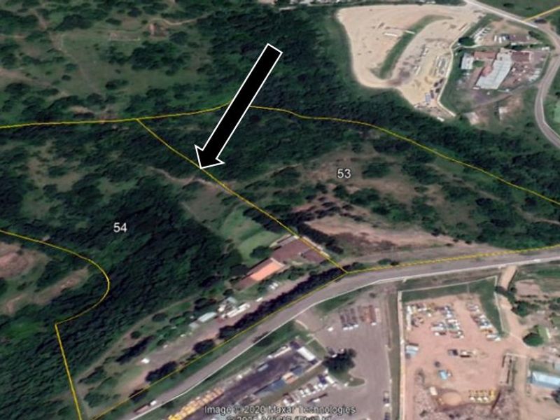 An aerial view showing the boundaries of land parcels 53 and 54, featuring natural vegetation and proximity to local road infrastructure.