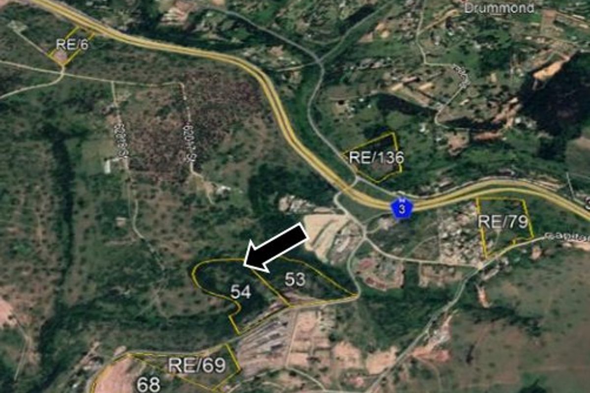 Aerial satellite view showing the property boundary and surrounding land parcels with highway proximity.