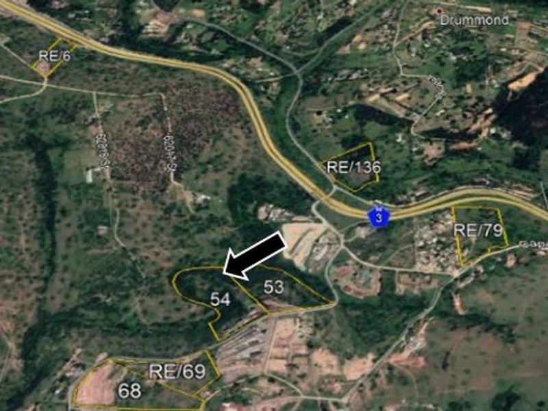 Aerial satellite view showing the property boundary and surrounding land parcels with highway proximity.