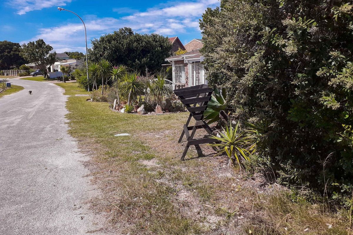 A view of the residential street showing the paved road, street lighting, and landscaped verge area adjacent to the property.