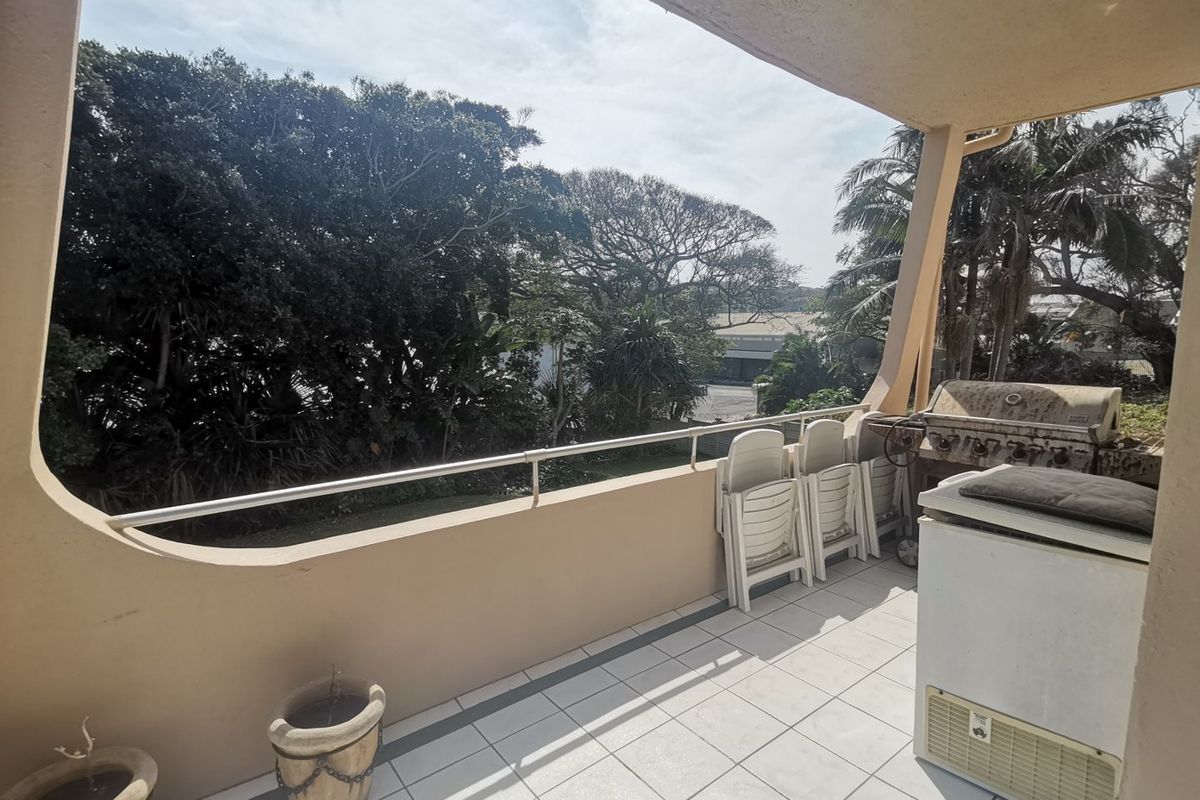 First floor corner unit with wrap around balcony and slight sea view through the trees - Photo 3