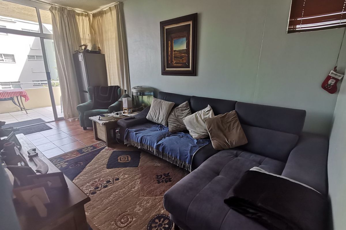 First floor corner unit with wrap around balcony and slight sea view through the trees - Photo 4