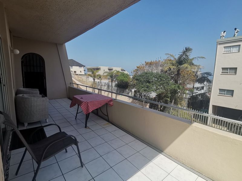 First floor corner unit with wrap around balcony and slight sea view through the trees - Photo 1