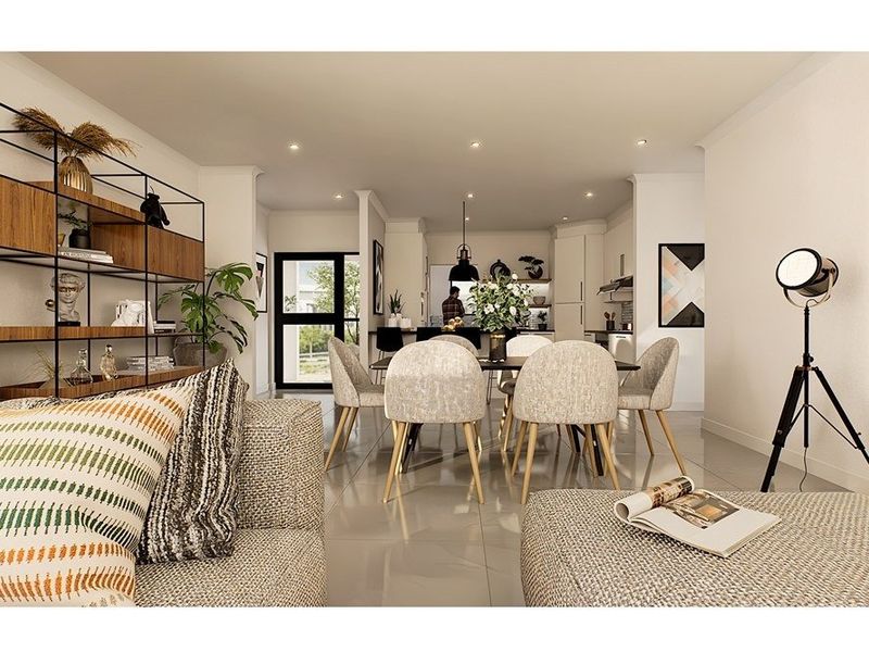 Modern open-plan living and dining area featuring tiled floors, recessed lighting, and a seamless transition to a contemporary kitchen space.