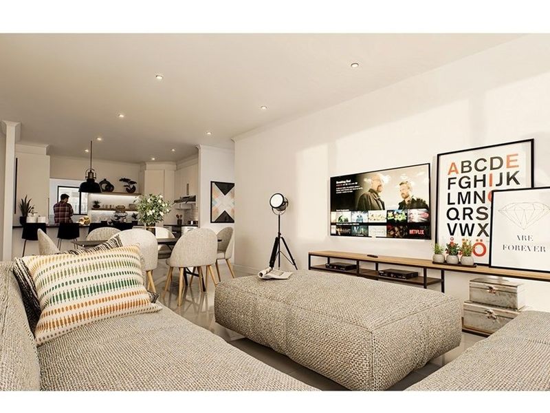 Modern open-plan living area featuring a seamless flow between the lounge and kitchen, highlighted by recessed lighting and contemporary finishes.