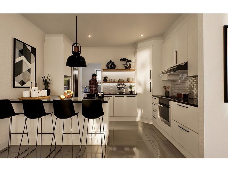 Modern kitchen featuring sleek white cabinetry, a functional island with breakfast bar seating, integrated appliances, and a stylish subway tile backsplash.