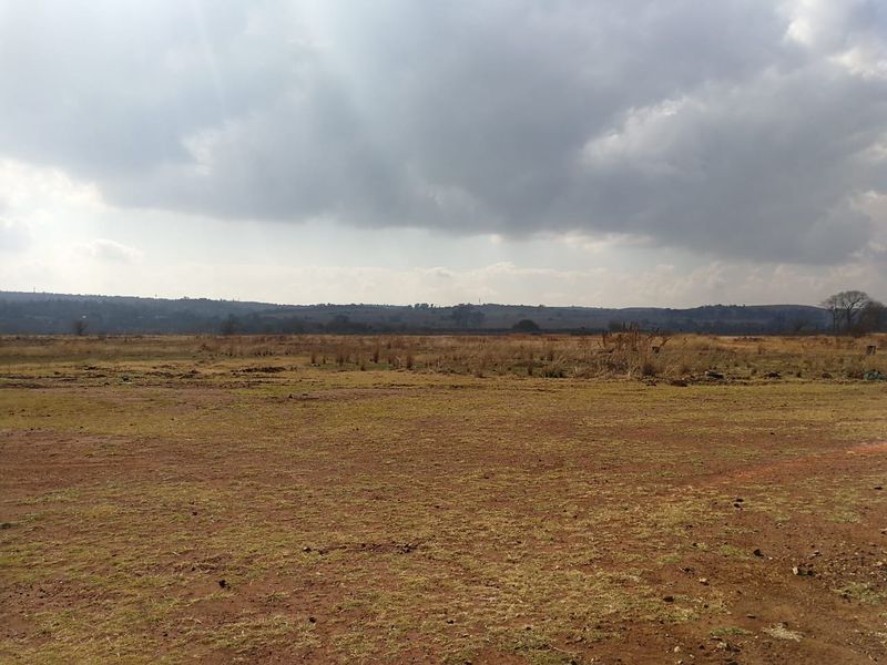 An expansive view of the vacant residential land, showcasing the natural landscape and open terrain available for future development.