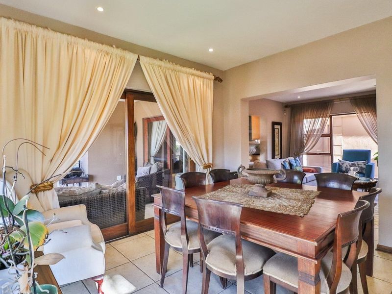 Open plan dining area featuring tiled flooring and large sliding glass doors providing access to the patio.