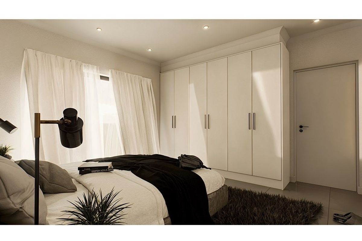 A modern bedroom featuring floor-to-ceiling built-in cupboards, recessed downlighting, and neutral tiled flooring.