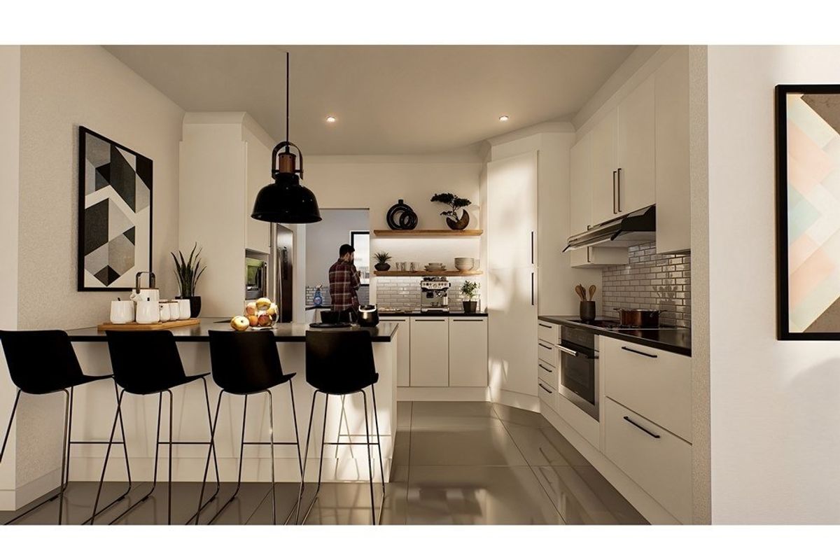 Modern kitchen featuring sleek white cabinetry, subway tile backsplash, integrated oven, extractor fan, and a functional breakfast bar island with pendant lighting.