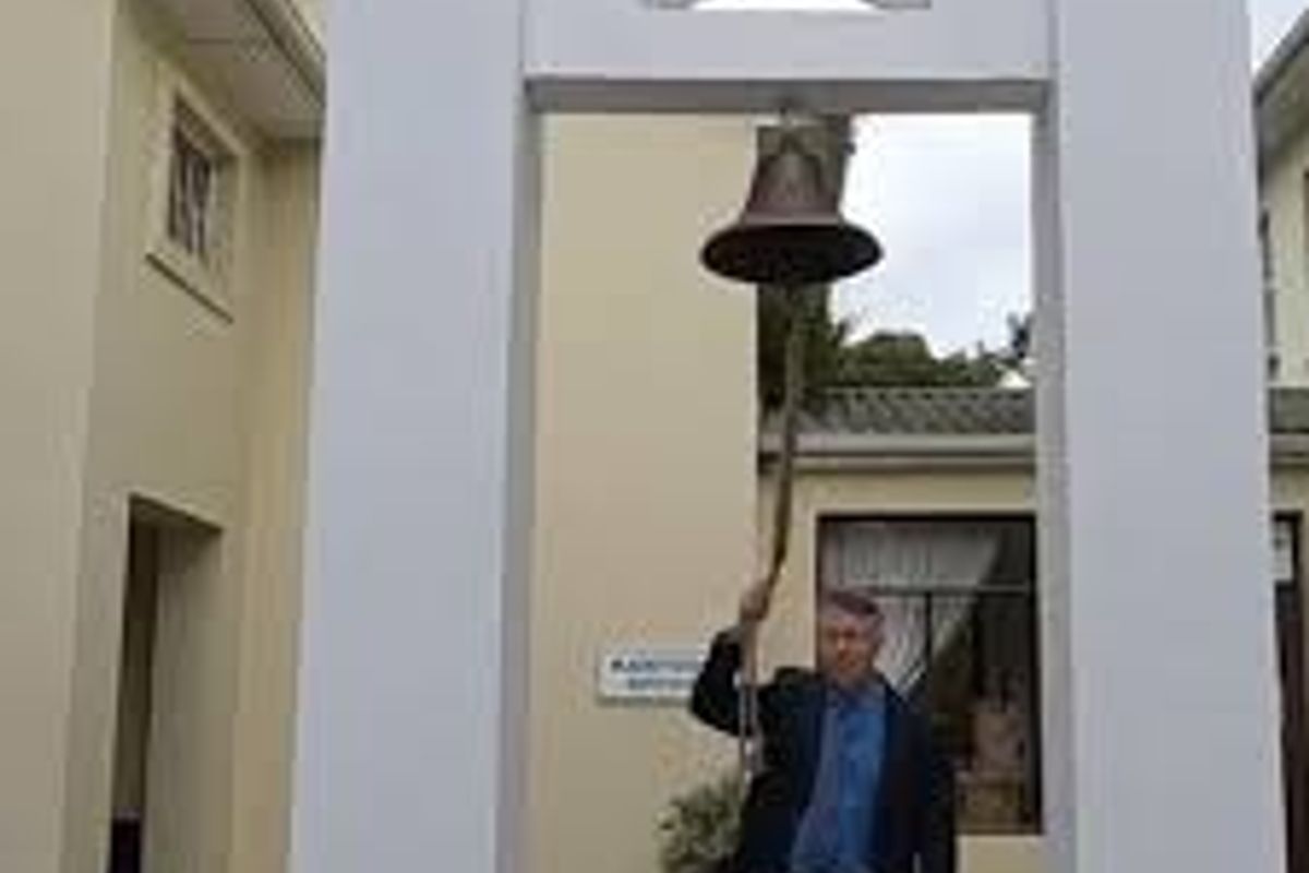 A decorative bell structure set within a courtyard area of the property.