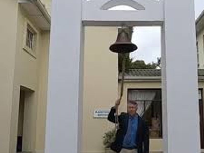 A decorative bell structure set within a courtyard area of the property.
