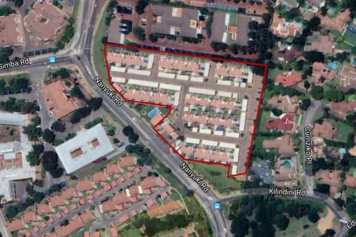 Aerial view of the apartment complex showing the site layout, access roads, and surrounding neighborhood infrastructure.