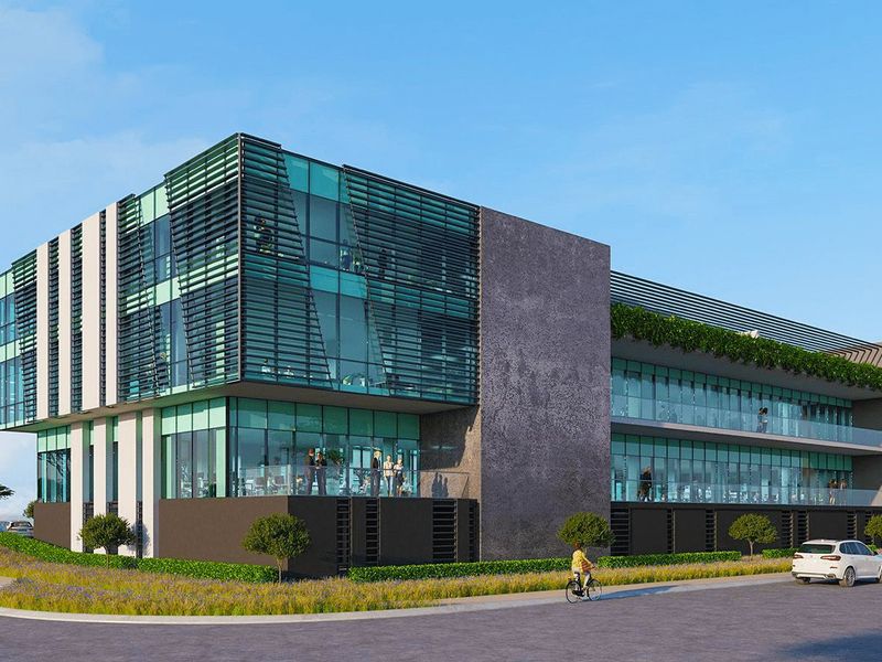 Modern commercial office building featuring a contemporary glass facade, integrated sun shading, and multi-level balconies with glass balustrades.