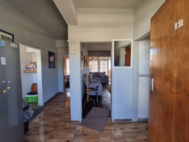 Entrance hallway featuring tiled flooring, providing access to the kitchen and living areas of the apartment.